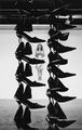 Lydia Dambassina, Untitled, 2007, installation detail, two colums of 72 pairs of shoes each and two photographs, 7 m x 90 cm
