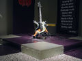 Dimitris Foutris, Possible stage for a heavy metal guitar solo performance (After Mortician’s Obliteration), 2005, digital print on vinyl, customised electric guitar, distortion pedal, amplifier, electric wires, spikes, wood base, silver paint, variable dimensions