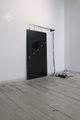 Dimitris Foutris, Gas lamps as angels (After Lisel Mueller΄s poem "Monet refuses the operation"), 2009, installation, wires, bulbs, black glass 160 x 90 cm, metal object, glossy white paint on wall, variable dimensions